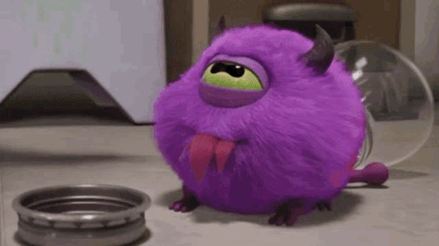 a purple monster with horns and a green eye is sitting next to a bowl of food .