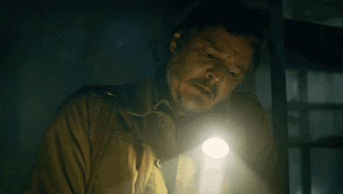 a man is holding a flashlight in his hand
