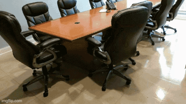 a conference room with a table and chairs with imgflip.com at the bottom of the image