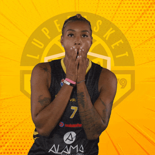 a female basketball player with the number 7 on her jersey covering her mouth