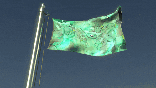 a green flag is flying in the wind
