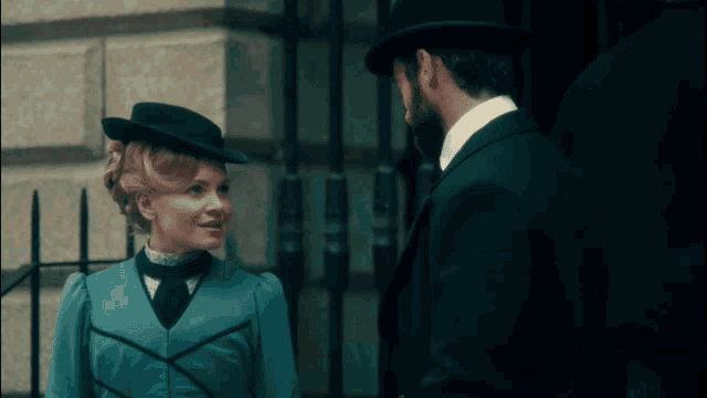 a man and a woman are standing next to each other and smiling