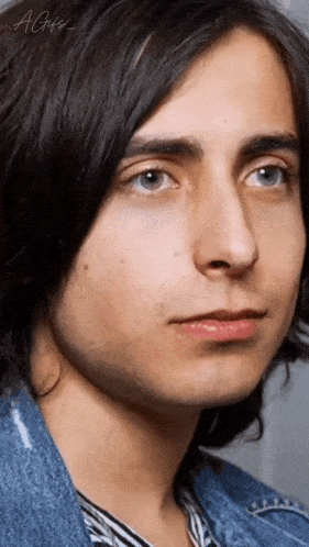 a close up of a young man 's face with the letters agfs on the bottom right
