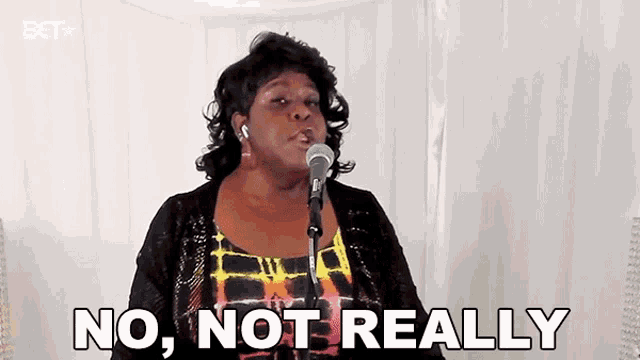 a woman is singing into a microphone with the words `` no , not really '' written next to her .