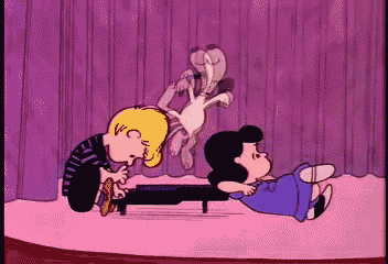 a cartoon of charlie brown playing a piano with lucy