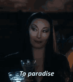 a woman with long black hair is holding a martini glass and saying to paradise