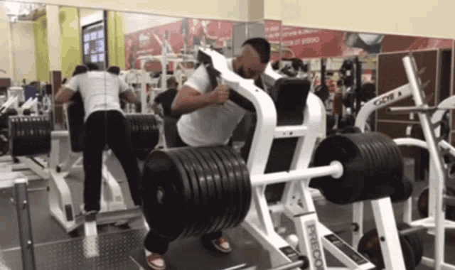 a man is doing squats on a machine that says o'neill on it