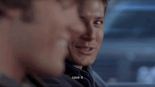 a man is smiling and saying `` save it '' while sitting in a car with another man .
