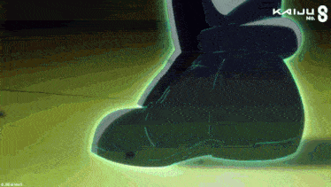 a person 's foot is glowing in the dark with kaiju no. 8 written on the bottom
