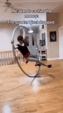 a woman is spinning a hula hoop in a living room with a caption .