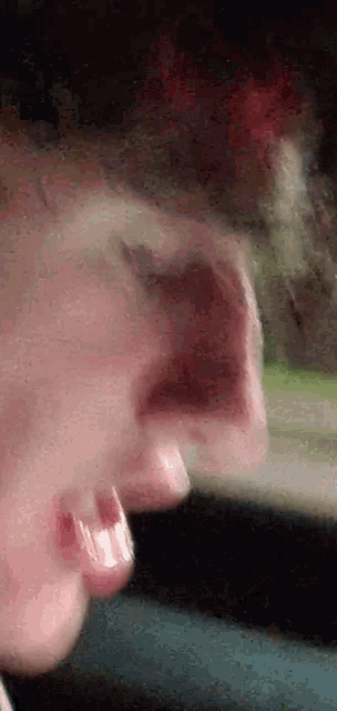 a close up of a person 's nose with a blurred background