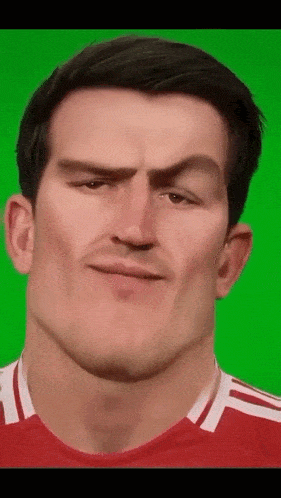 a close up of a man 's face with a green screen in the background .