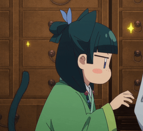 a girl with a cat ear on her head is looking at something