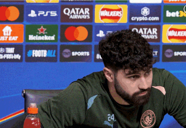 a man with a beard wearing a green shirt with the number 24 on the front