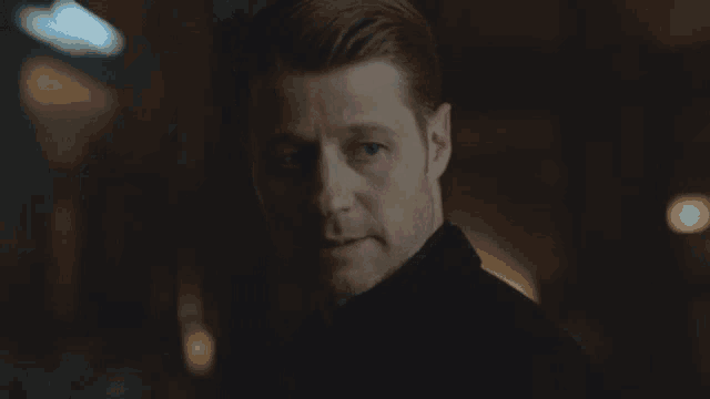 a close up of a man 's face looking at the camera