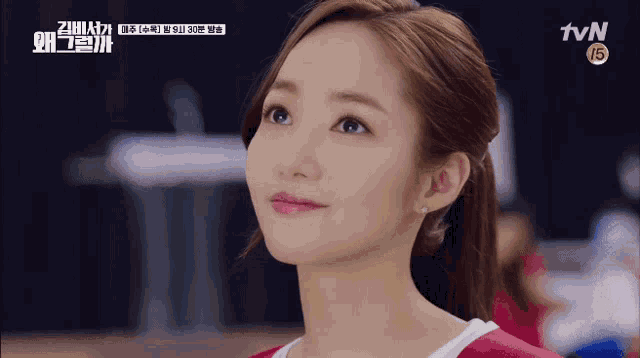a close up of a woman 's face with a tvn logo in the background