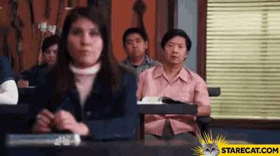 a group of people are sitting in a classroom with a starcat.com logo on the bottom right