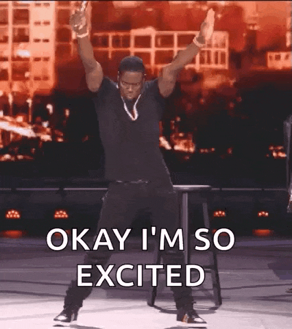 a man is dancing on a stage with his arms in the air and the words `` okay i 'm so excited '' .