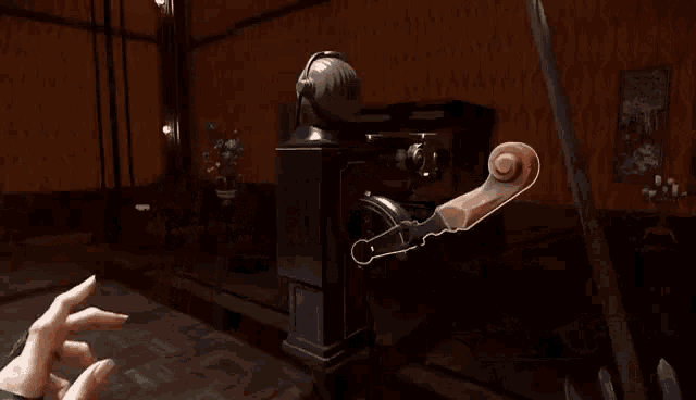 a person is playing a video game in a dark room with a staircase in the background .