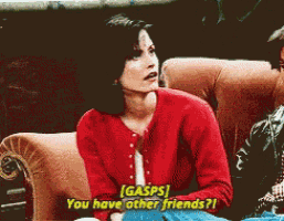 a woman in a red sweater is sitting on a couch asking if she has other friends