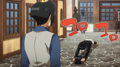 a man in a blue shirt is looking at a man on his knees in front of a sign that says " go "
