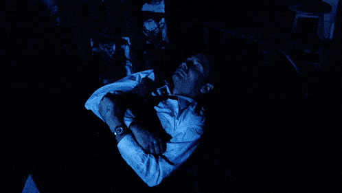 a dark room with a blue light shining on a wall