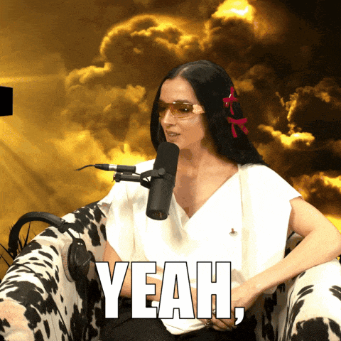 a woman sitting in front of a microphone with the word yeah written on the bottom