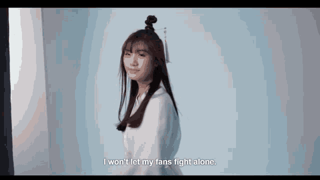 a woman with a bun in her hair says " i won t let my fans fight alone "
