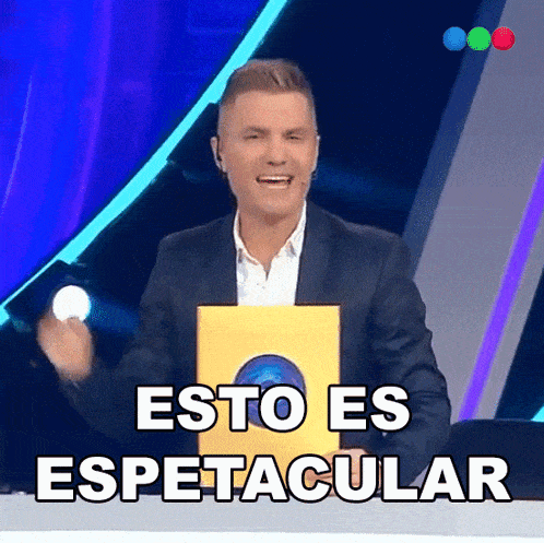 a man in a suit is holding a yellow box that says esto es espetacular