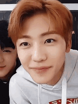 a close up of a person 's face with a hoodie that says nct dream