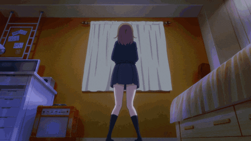 a girl stands in front of a window with a sign on the wall that says ' a '