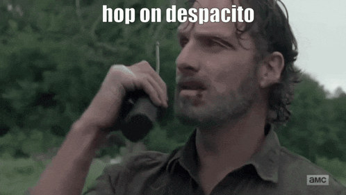 a man talking on a walkie talkie with the words hop on despacito written above him