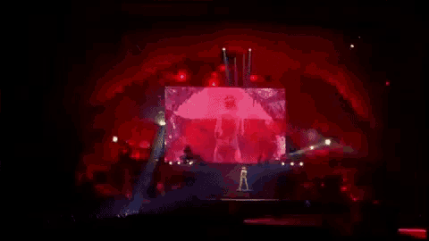 a woman is dancing on a stage in a very short dress .