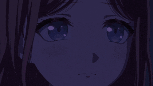 a close up of a girl 's eyes with a purple background