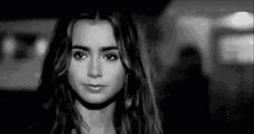a black and white photo of a beautiful young woman with long hair .