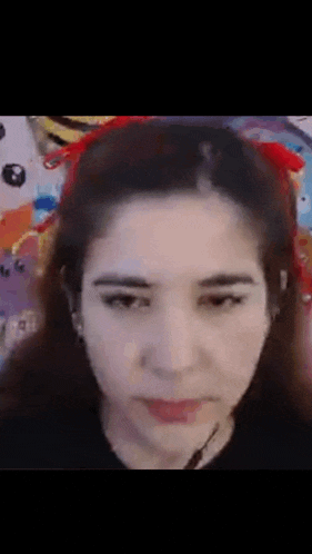 a close up of a woman 's face with a red headband on her head .