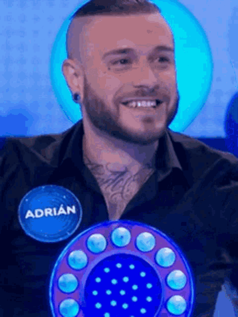 a man with a beard is wearing a name tag that says adrian