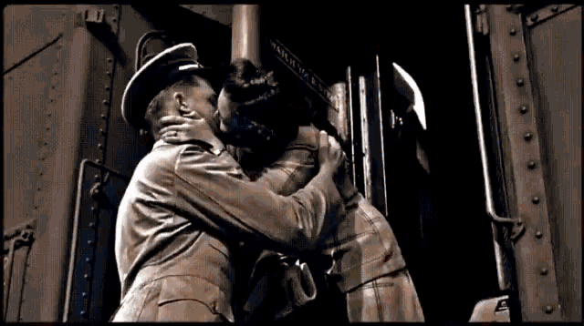 a man in a hat is hugging another man in a black and white photo with the word " army " on it
