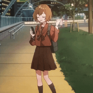 a girl in a school uniform is walking down a sidewalk holding a cell phone