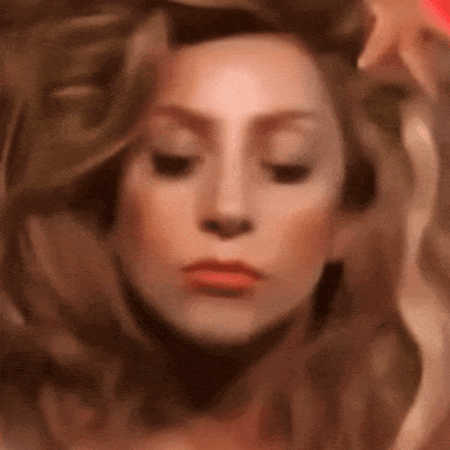 a blurry picture of a woman 's face with her eyes closed