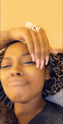 a woman with long pink nails holds her hand to her forehead with the word bitch above it