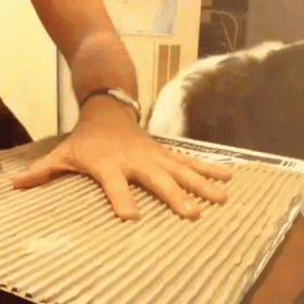 a close up of a person 's hand on a cardboard box