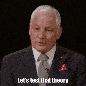 a man in a suit and tie is saying " let 's test that theory "