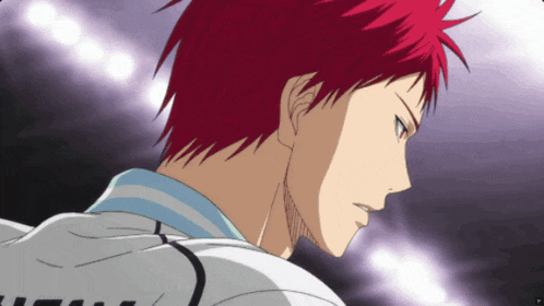 a man with red hair is wearing a white shirt with the letter t on the back