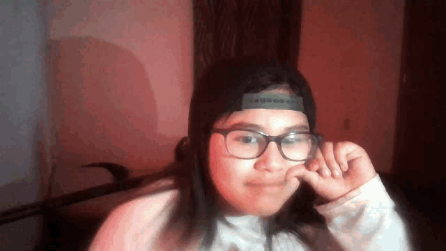 a girl wearing glasses and a hat that says ' abercrombie ' on it