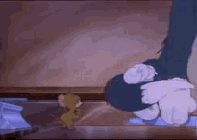 a cartoon of tom and jerry fighting each other in a bathroom .