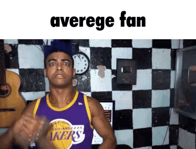 a man wearing a los angeles lakers jersey makes a funny face