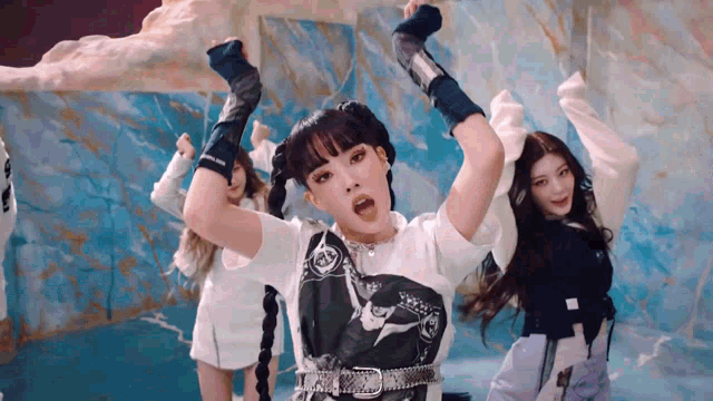 a group of girls are dancing in front of a blue background .