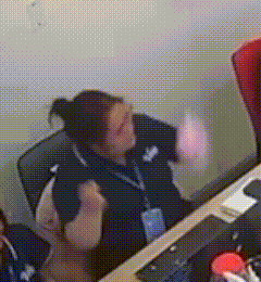 a woman is sitting at a desk with a name tag that says ' aa ' on it