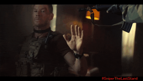 a man holding a gun with a flame coming out of it with #sniper the last stand written on the bottom